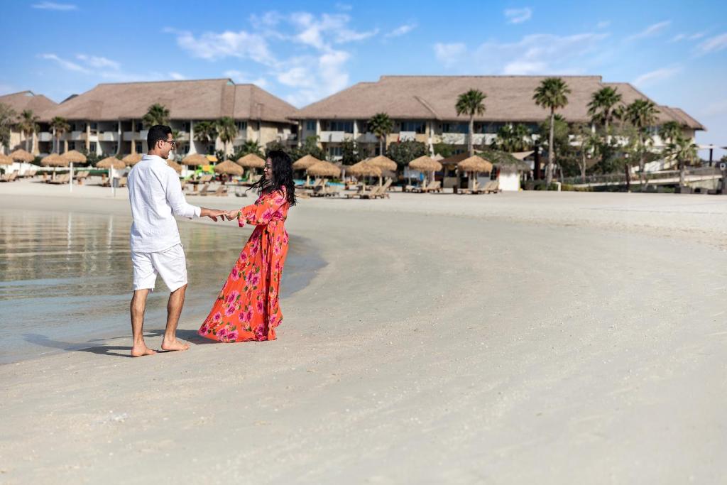 A couple walking along the resort's beach